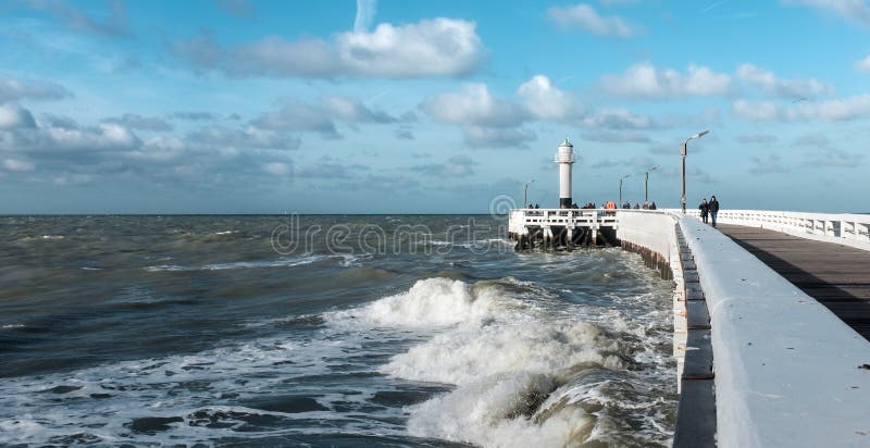 Waves smashing into the old wooden pier of Nieuwpoort in Belgium