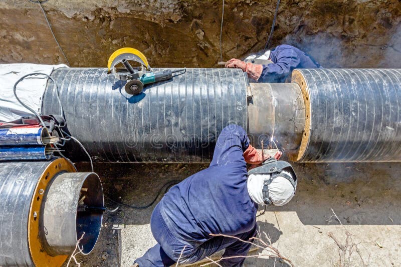 View on welding team of welders until them assembly a new pipeline royalty free stock photo View on welding team of welders until them assembly a new pipeline royalty free stock photo