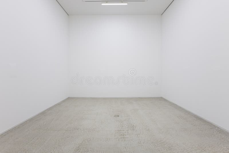 A view of a white painted interior of an empty room or an art gallery with a fluorescent lighting and wood floors royalty free stock image A view of a white painted interior of an empty room or an art gallery with a fluorescent lighting and wood floors royalty free stock image