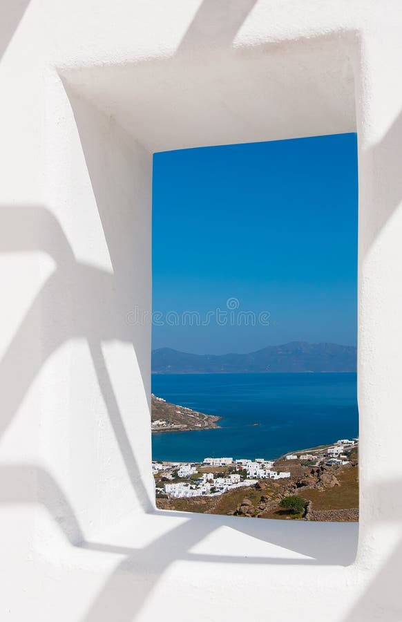 View through a white wall window to the sea and coast