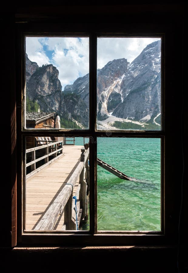View from the window of Lake Braies with vivid colors in spring with mountains in the background