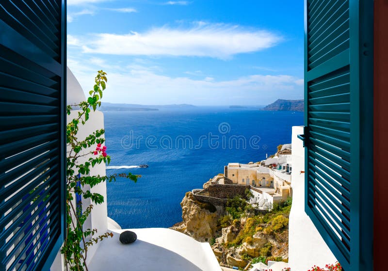 View from a window overlooking the sea, caldera and whitewashed village of Oia on the island of Santorini Greece stock images View from a window overlooking the sea, caldera and whitewashed village of Oia on the island of Santorini Greece stock images