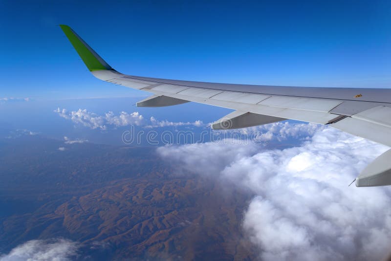 View from the window of the plane to the cumulus clouds and the infinitely blue sky. stock photos View from the window of the plane to the cumulus clouds and the infinitely blue sky. stock photos