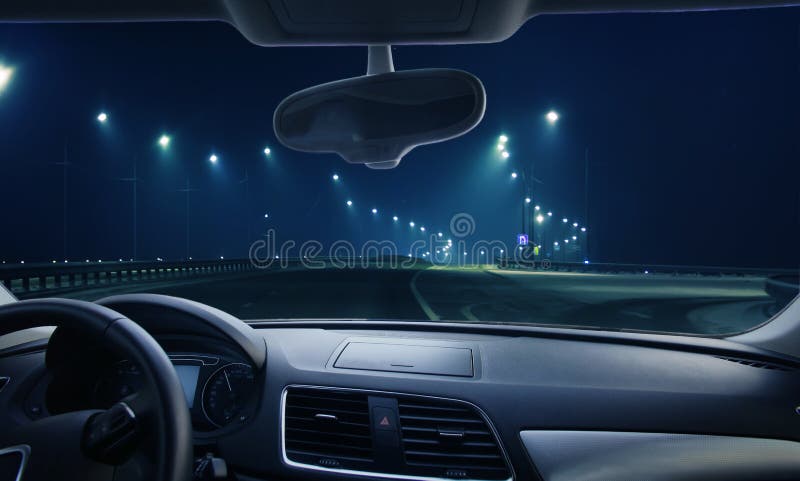 View through the windshield of the car.Winter highway at night