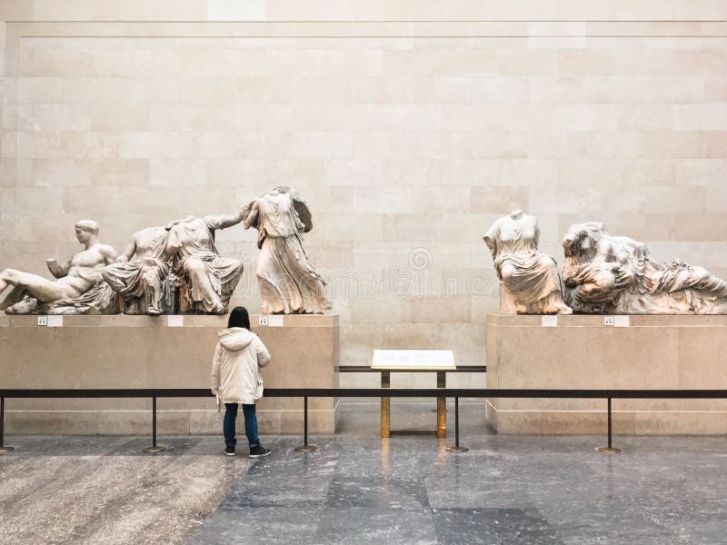 View woman observing the friezes of the Parthenon in the British Museum