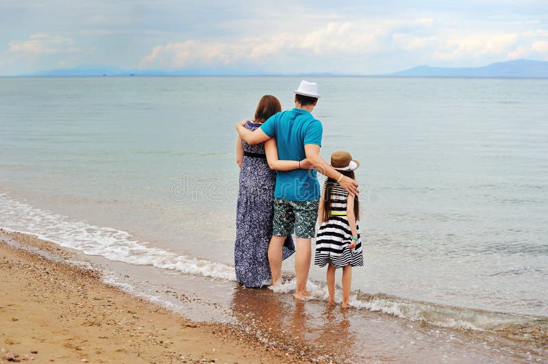 View of young family having fun on the beach