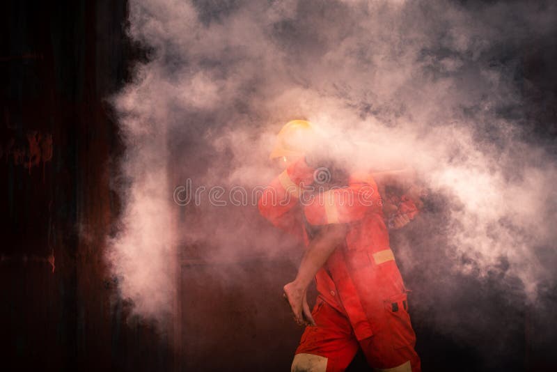 Vigile del fuoco con l'equipaggiamento per aiutare le persone intrappolate negli incendi delle case. Vigile del fuoco con l'attrezzatura cerca di aiutare le persone intrappolate in una casa coperta da incendi con fumo