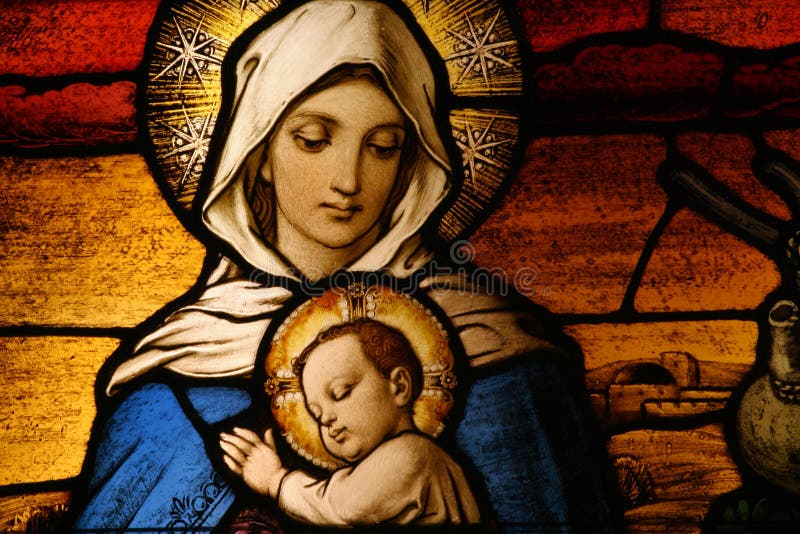 Stained glass depicting the Virgin Mary holding baby Jesus. Stained glass depicting the Virgin Mary holding baby Jesus