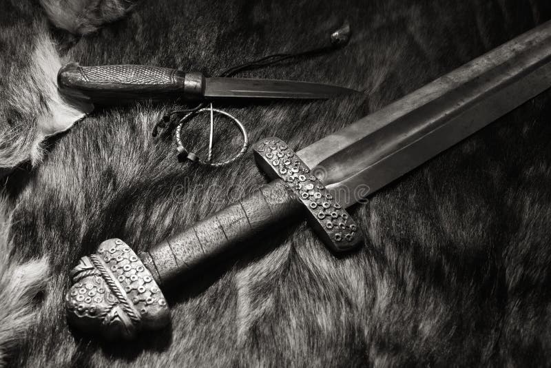 Viking sword and knife on a fur stock images Viking sword and knife on a fur stock images
