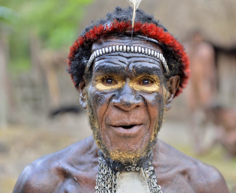 DANI VILLAGE, WAMENA, IRIAN JAYA, NEW GUINEA, INDONESIA, 15 MAY 2016: Close up Portrait of Yali Mabel, the chief of Dani tribe. Dugum Dani Warrior. May 15, 2016. Baliem Valley, Indonesian, New Guinea. DANI VILLAGE, WAMENA, IRIAN JAYA, NEW GUINEA, INDONESIA, 15 MAY 2016: Close up Portrait of Yali Mabel, the chief of Dani tribe. Dugum Dani Warrior. May 15, 2016. Baliem Valley, Indonesian, New Guinea