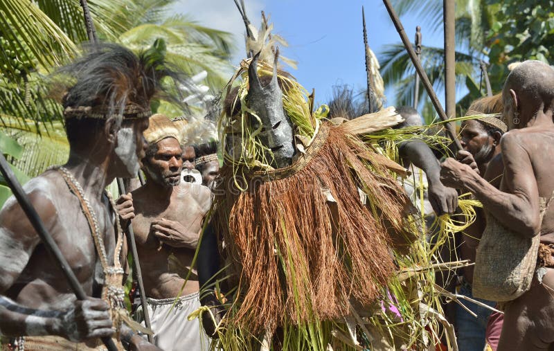 YOUW VILLAGE, ATSY DISTRICT, ASMAT, NEW GUINEA, INDONESIA - MAY 23: The Village follows the ancestors embodied in spirit mask as they tour the village. Jjungle of New Guinea.Indonesia. May 23, 2016. YOUW VILLAGE, ATSY DISTRICT, ASMAT, NEW GUINEA, INDONESIA - MAY 23: The Village follows the ancestors embodied in spirit mask as they tour the village. Jjungle of New Guinea.Indonesia. May 23, 2016