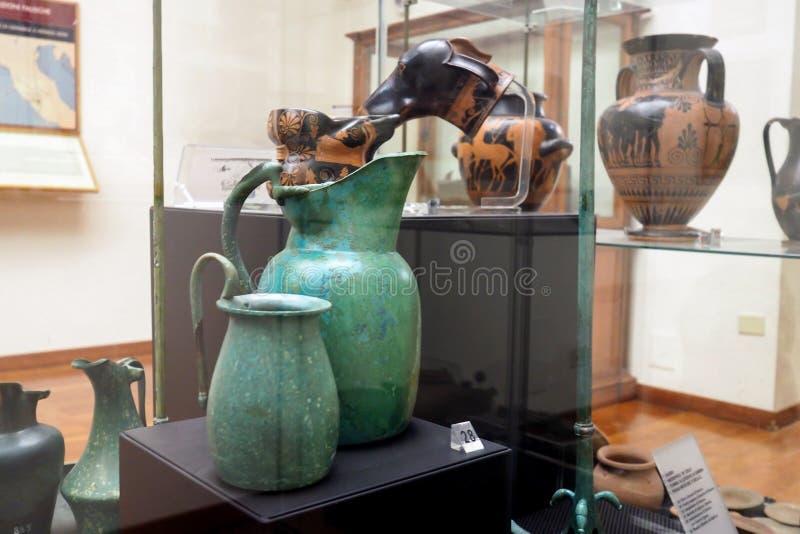 Aristocratic grave goods originating from Falerii in the National Etruscan Museum of Villa Giulia in Rome, Italy. The Greece ceramic documents the flourishing of the aristocracy in the fifth century. They document the influence of the Etruscan on the populations like the Faliscan due to the geographic proximity in the northern Lazio, on the Etruscan side of the Tiber River. Created in 1899, the Etruscan Museum of Villa Giulia houses works from pre-Roman Italian antiquity, especially from the Etruscan world. Among the museum’s most valuable objects are a sarcophagus from the year 520 BC, as well as several terracotta figures such as the Apollo of Veii and the image of Hercules and Apollo vying for the deer, both from 510 BC. The museum also presents a great collection of precious objects from antiquity to the 19th century. Aristocratic grave goods originating from Falerii in the National Etruscan Museum of Villa Giulia in Rome, Italy. The Greece ceramic documents the flourishing of the aristocracy in the fifth century. They document the influence of the Etruscan on the populations like the Faliscan due to the geographic proximity in the northern Lazio, on the Etruscan side of the Tiber River. Created in 1899, the Etruscan Museum of Villa Giulia houses works from pre-Roman Italian antiquity, especially from the Etruscan world. Among the museum’s most valuable objects are a sarcophagus from the year 520 BC, as well as several terracotta figures such as the Apollo of Veii and the image of Hercules and Apollo vying for the deer, both from 510 BC. The museum also presents a great collection of precious objects from antiquity to the 19th century.