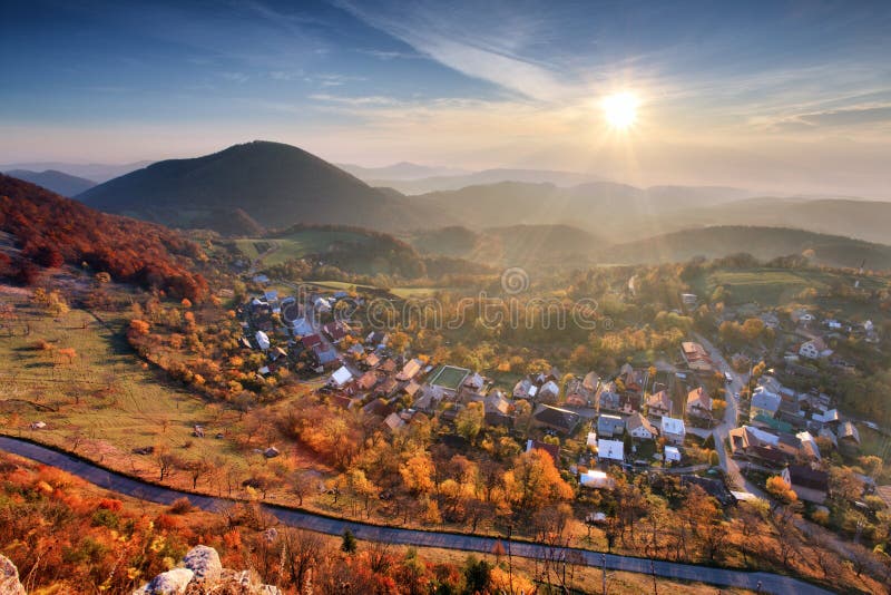 Village at autumn with sun