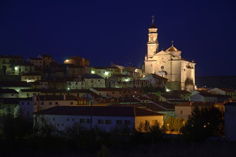 Village with cathedral by night