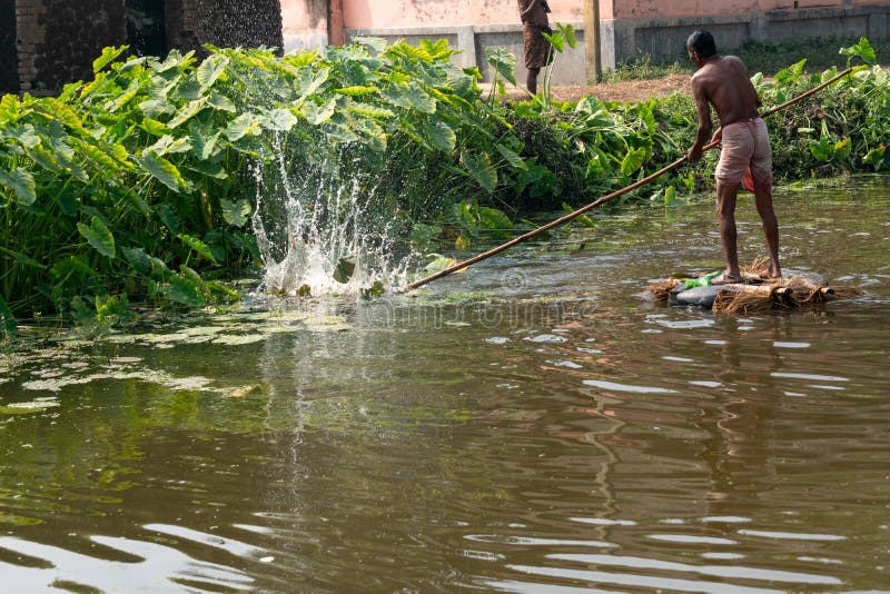 A Village Fisherman is Throwing a Net for Fishing in a Pond Editorial
