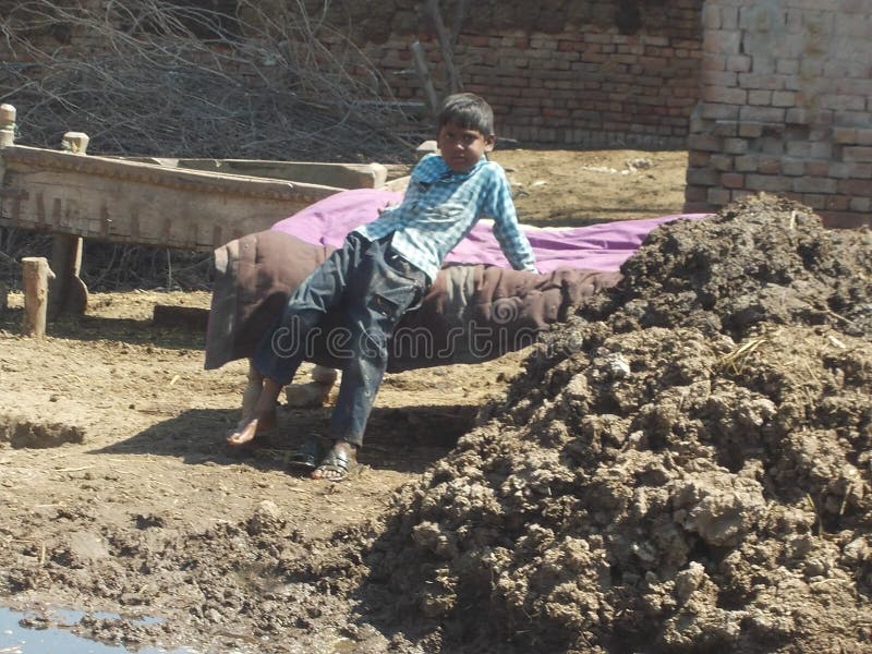 Village life of a poor young boy in Pakistan stock image