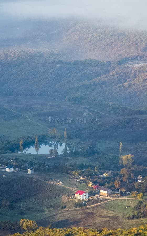Village in a Mountain Valley. a Lake Near a Village in the Valley Stock
