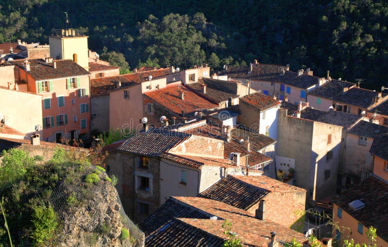 Small medieval village with old beautiful traditional houses on the hills in Provence, France. Sunset light, view from above. Small medieval village with old beautiful traditional houses on the hills in Provence, France. Sunset light, view from above