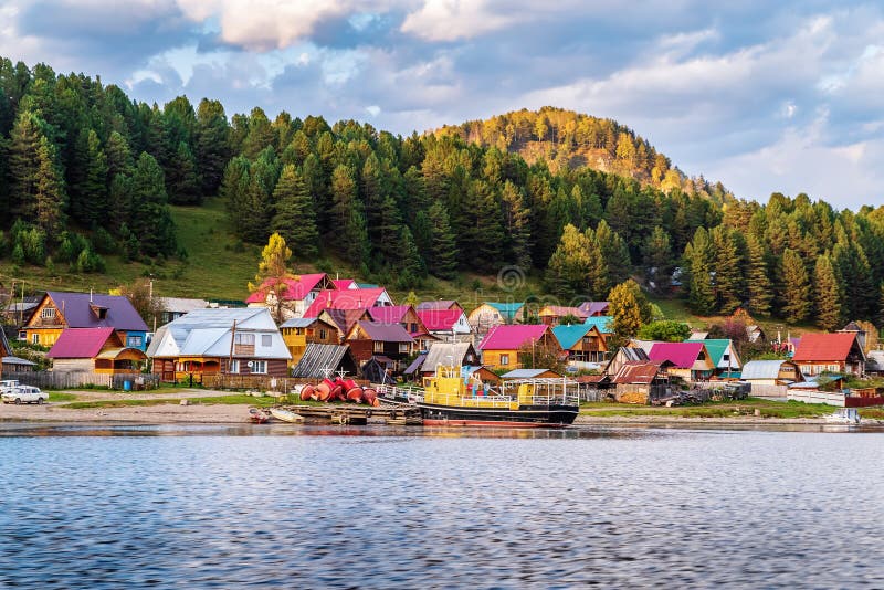 Village with a pier on the shore of a mountain lake