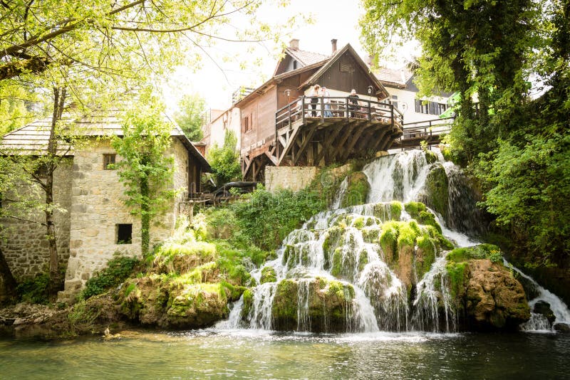 Village of Rastoke by a Korana river with wooden houses and a waterfall, Croatia