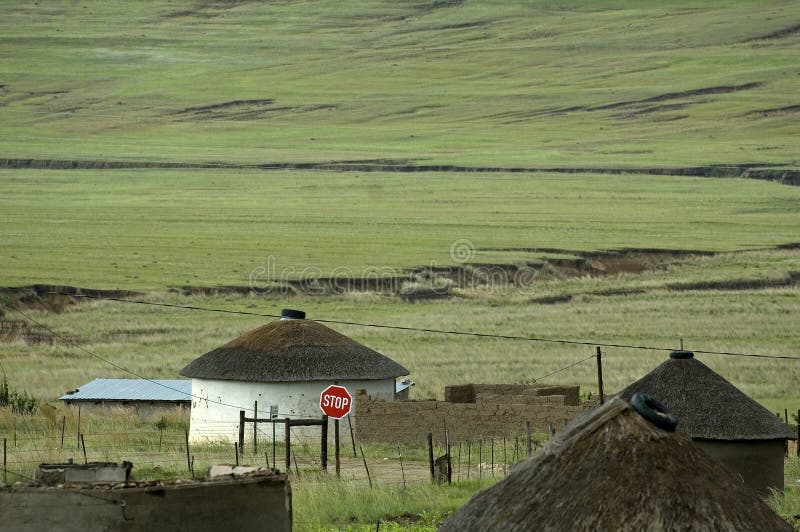 A basotho village in South Africa with an incongruous stop sign on the main path. A basotho village in South Africa with an incongruous stop sign on the main path.