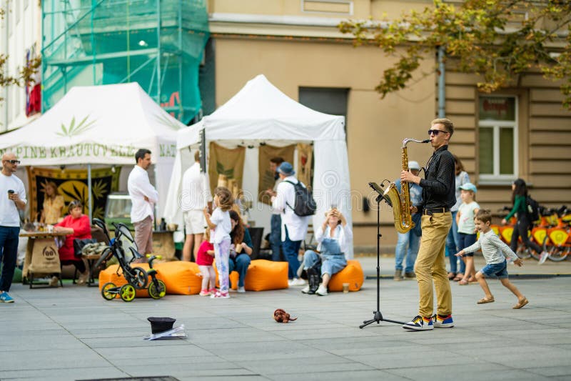 VILNIUS, LITHUANIA - SEPTEMBER 3, 2023: Street musician performing at Nations Fair, where masters from the national communities of Lithuania present their arts, national customs and traditions. VILNIUS, LITHUANIA - SEPTEMBER 3, 2023: Street musician performing at Nations Fair, where masters from the national communities of Lithuania present their arts, national customs and traditions