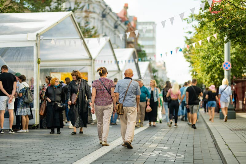 VILNIUS, LITHUANIA - SEPTEMBER 3, 2023: People attending annual Nations Fair, where masters from the national communities of Lithuania present their arts, crafts, national customs and traditions. VILNIUS, LITHUANIA - SEPTEMBER 3, 2023: People attending annual Nations Fair, where masters from the national communities of Lithuania present their arts, crafts, national customs and traditions