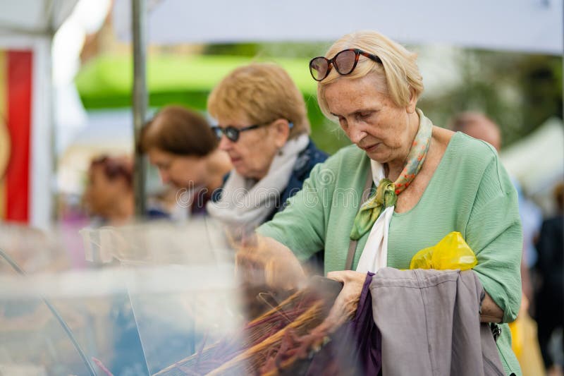 VILNIUS, LITHUANIA - SEPTEMBER 3, 2023: People attending annual Nations Fair, where masters from the national communities of Lithuania present their arts, crafts, national customs and traditions. VILNIUS, LITHUANIA - SEPTEMBER 3, 2023: People attending annual Nations Fair, where masters from the national communities of Lithuania present their arts, crafts, national customs and traditions