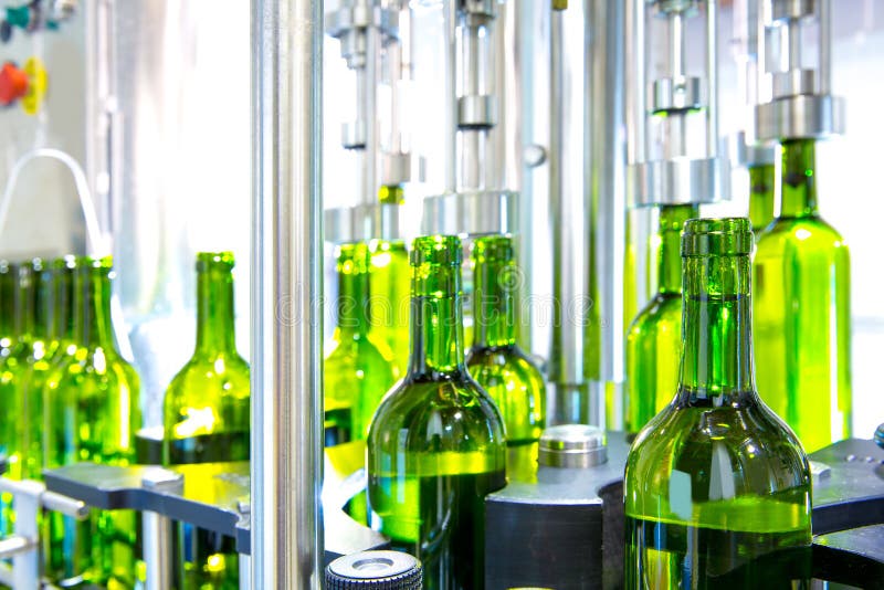 Vinho branco na máquina de engarrafamento na adega imagens de stock Vinho branco na máquina de engarrafamento na adega imagens de stock