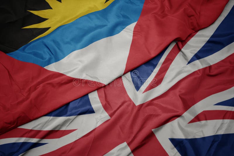 waving colorful flag of great britain and national flag of antigua and barbuda. macro. waving colorful flag of great britain and national flag of antigua and barbuda. macro