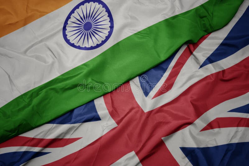 waving colorful flag of great britain and national flag of india. macro. waving colorful flag of great britain and national flag of india. macro