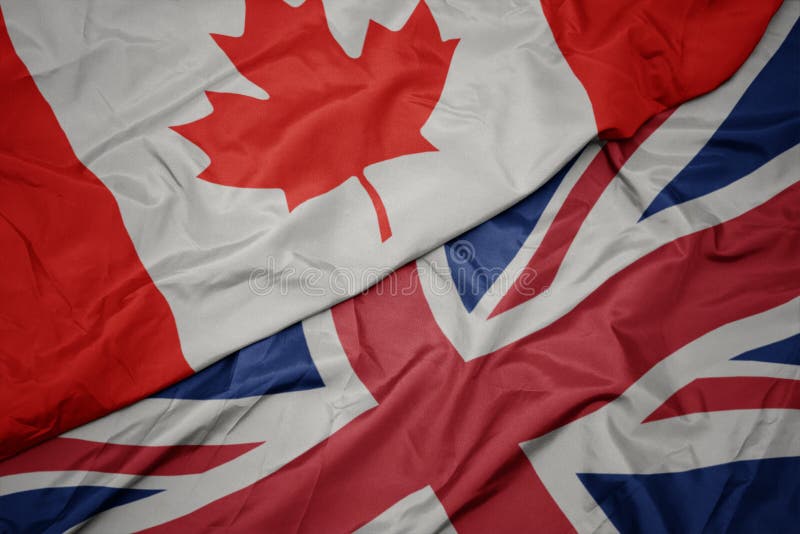 waving colorful flag of great britain and national flag of canada. macro. waving colorful flag of great britain and national flag of canada. macro