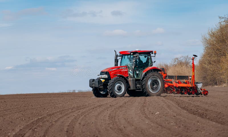 Vinnitsa, Ukraine - April 20, 2022: Spring sowing season. Farmer with a tractor sows corn seeds on his field
