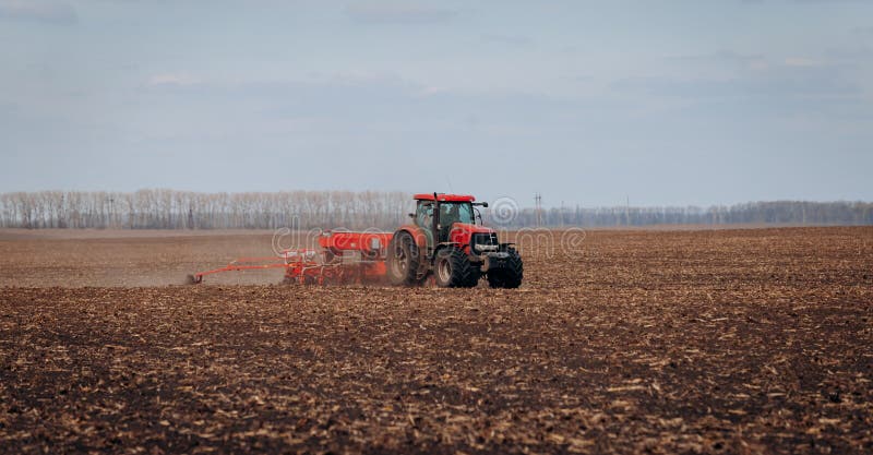 Vinnitsa, Ukraine - April 20, 2022: Spring sowing season. Farmer with a tractor sows corn seeds on his field