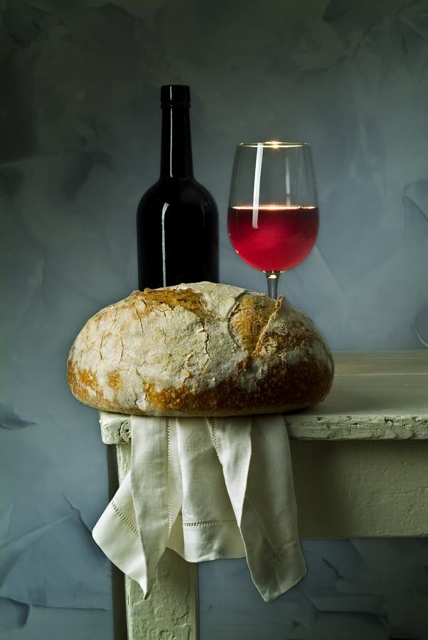 Red wine glass, bottle and loaf of sour dough bread. Red wine glass, bottle and loaf of sour dough bread