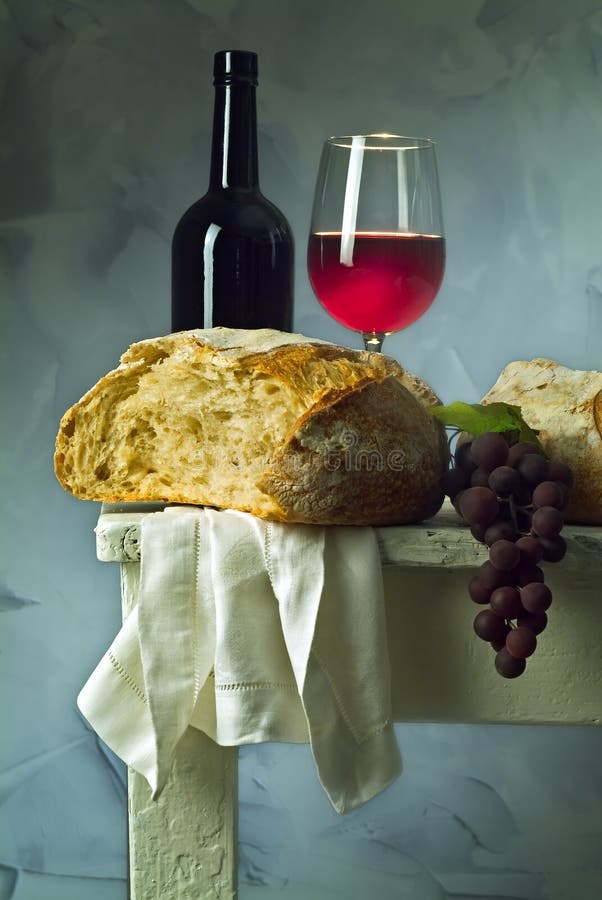 Red wine glass, bottle and loaf of sour dough bread. Red wine glass, bottle and loaf of sour dough bread