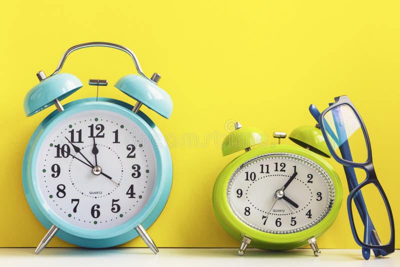 Vintage Alarm Clocks with Glasses on Yellow. Stock Image Image of