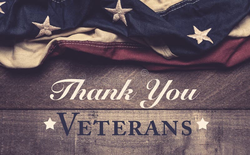 An American flag or bunting on a wooden background with veteran`s day greeting stock photos An American flag or bunting on a wooden background with veteran`s day greeting stock photos