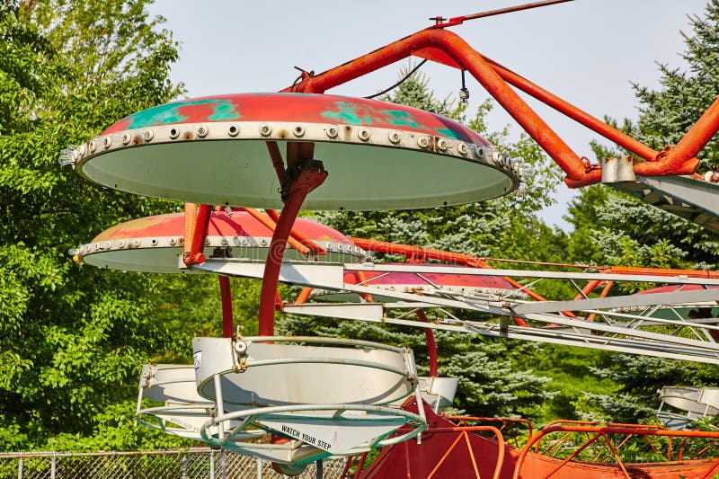 Vintage Amusement Park Ride with Rustic Charm, Green Canopy Background