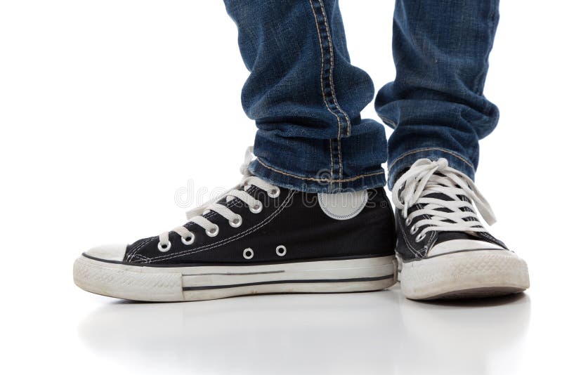 A pair o f vintage looking, athletic shoes and skinny jeans on a white background with copy space. Concept f retro style stock images, royalty-free photos and pictures