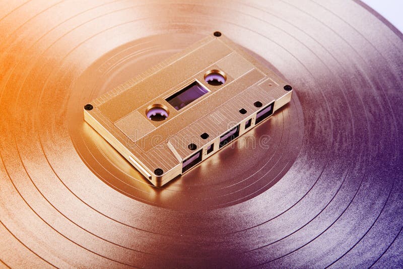 Vintage Audio Cassette and Vinyl Record. Analog Data Stock Photo