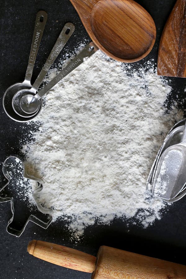 Vintage Baking Supplies Surrounding Pile of White Baking Flour stock photography Vintage Baking Supplies Surrounding Pile of White Baking Flour stock photography