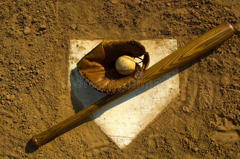 Vintage baseball with bat on home plate. Vintage baseball with bat on home plate