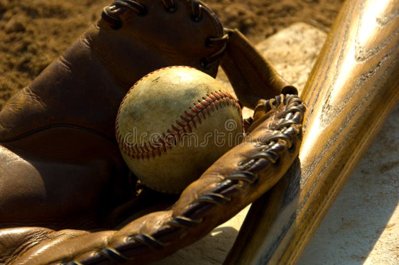 Vintage baseball with bat on home plate. Vintage baseball with bat on home plate