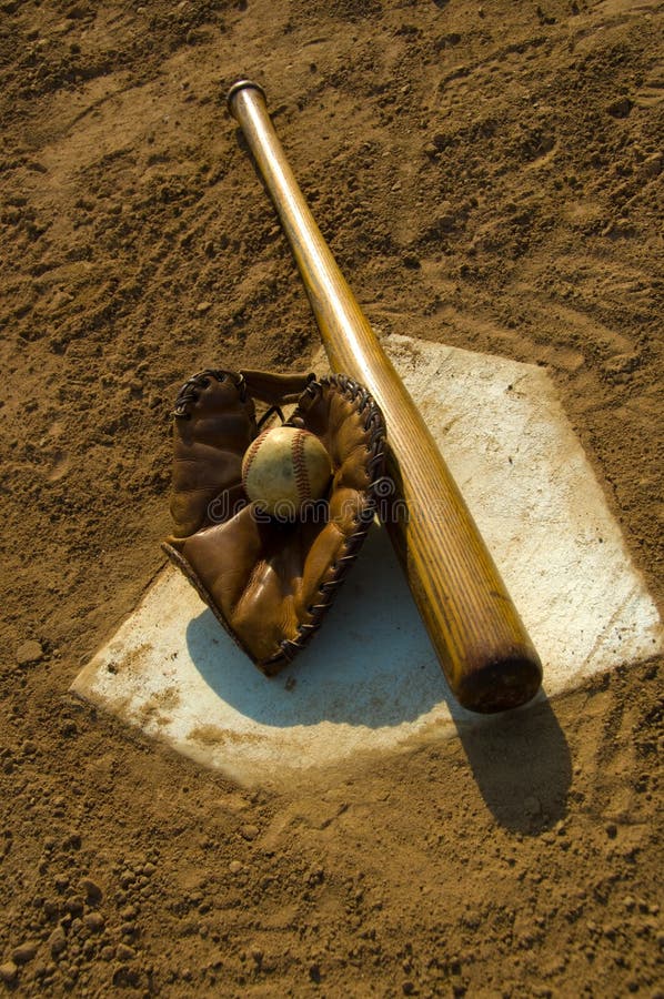 Vintage baseball with bat on home plate. Vintage baseball with bat on home plate