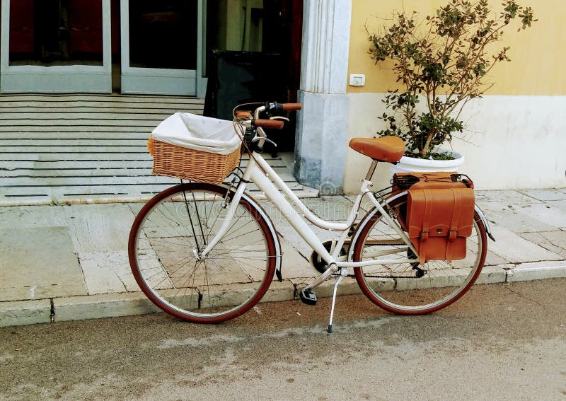 Vintage bike for picnic stands near the brick wall of Italian city.