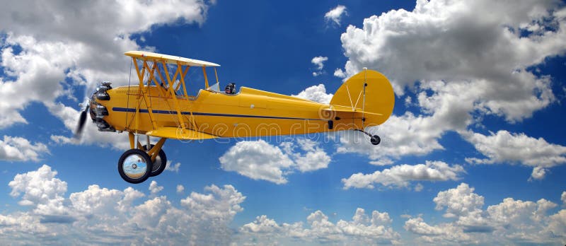 Vintage Biplane Over Clouds stock photo