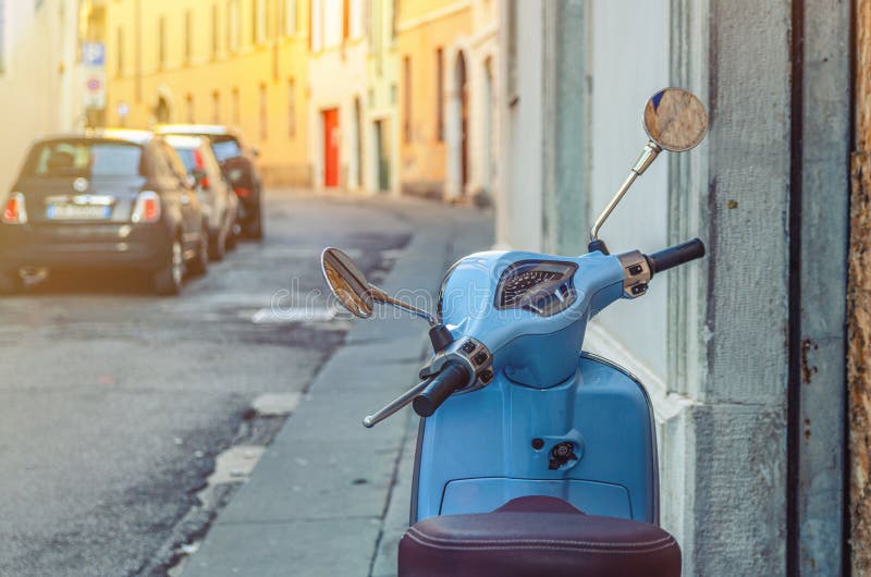 Vintage blue scooter motorbike Vespa in narrow italian empty street royalty free stock image Vintage blue scooter motorbike Vespa in narrow italian empty street royalty free stock image