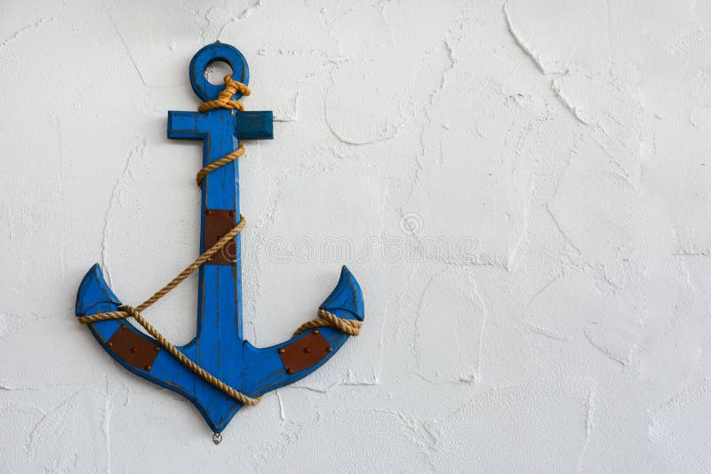 A vintage blue wood anchor on white plaster cement texture wall background, copy space stock photos
