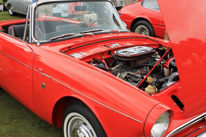 classic british sports car hood open and American ford engine under the hood. red 1965 sunbeam tiger mk1 sports car. at concours car event in south florida. classic british sports car hood open and American ford engine under the hood. red 1965 sunbeam tiger mk1 sports car. at concours car event in south florida.